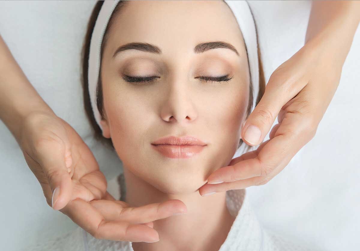 a woman is receiving a spa treatment for her face as she relaxes and closes her eyes