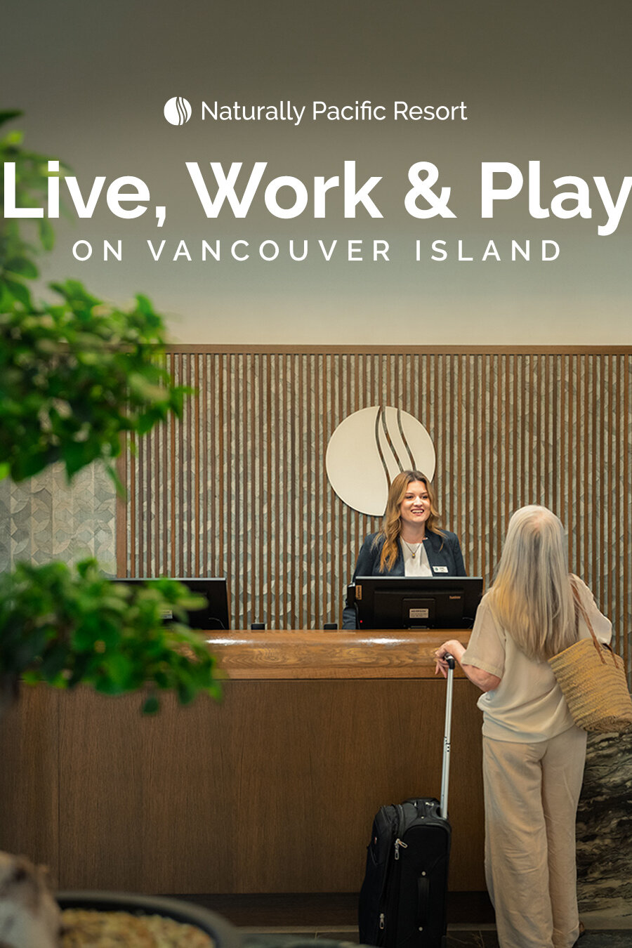 A reception desk agent checking in a hotel guest.